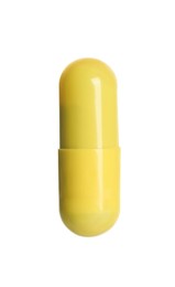 Photo of One yellow pill isolated on white. Medicinal treatment