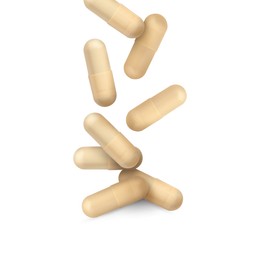 Image of Vitamin. Many capsules falling on white background