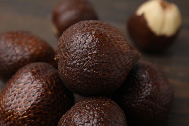 Photo of Pile of fresh salak fruits on table, closeup