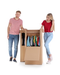 Photo of Young couple near wardrobe boxes on white background