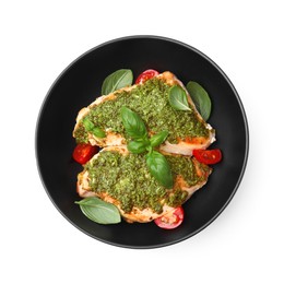 Photo of Delicious chicken breasts with pesto sauce, tomatoes and basil isolated on white, top view