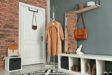 Photo of Stylish hallway interior with mirror and hanger stand