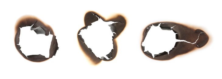 Image of Paper with burnt holes on white background