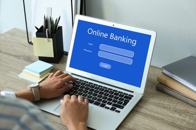 Image of Woman using online banking application on laptop at table, closeup