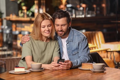 Photo of Romantic date. Lovely couple spending time together in cafe