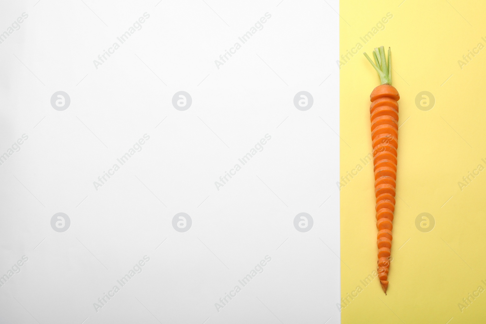 Photo of Fresh sliced carrot and space for text on color background, top view