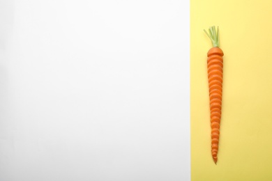 Photo of Fresh sliced carrot and space for text on color background, top view