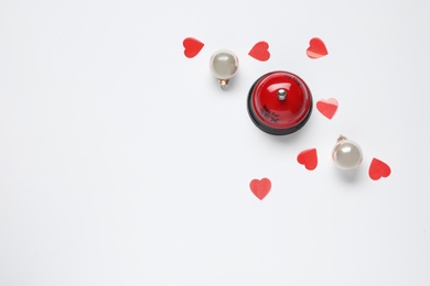 Photo of Service bell with words RING FOR SEX, Christmas balls and red hearts on white background, top view