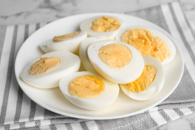 Photo of Tasty hard boiled eggs on ceramic plate