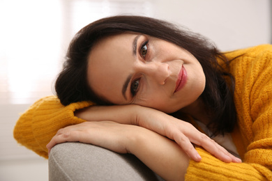 Photo of Beautiful mature woman on sofa at home