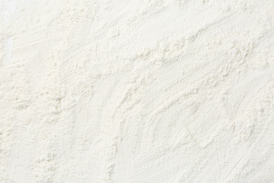 Photo of Pile of organic flour as background, top view