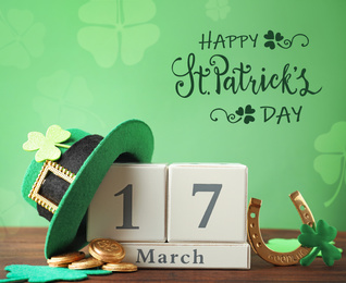 Image of Composition with block calendar on wooden table. St. Patrick's Day celebration