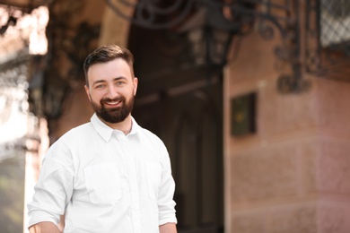 Photo of Portrait of young businessman in stylish outfit outdoors