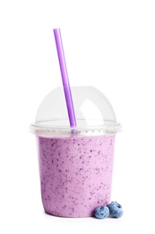 Photo of Tasty blueberry smoothie in plastic cup on white background