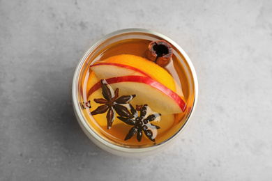 Photo of Aromatic white mulled wine on light grey table, top view