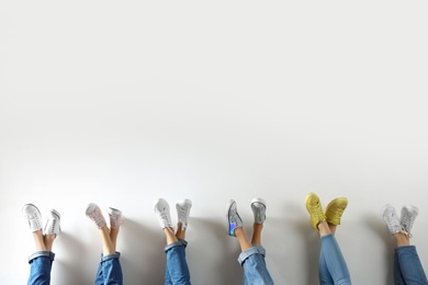 Photo of Young women in modern shoes on white background, closeup