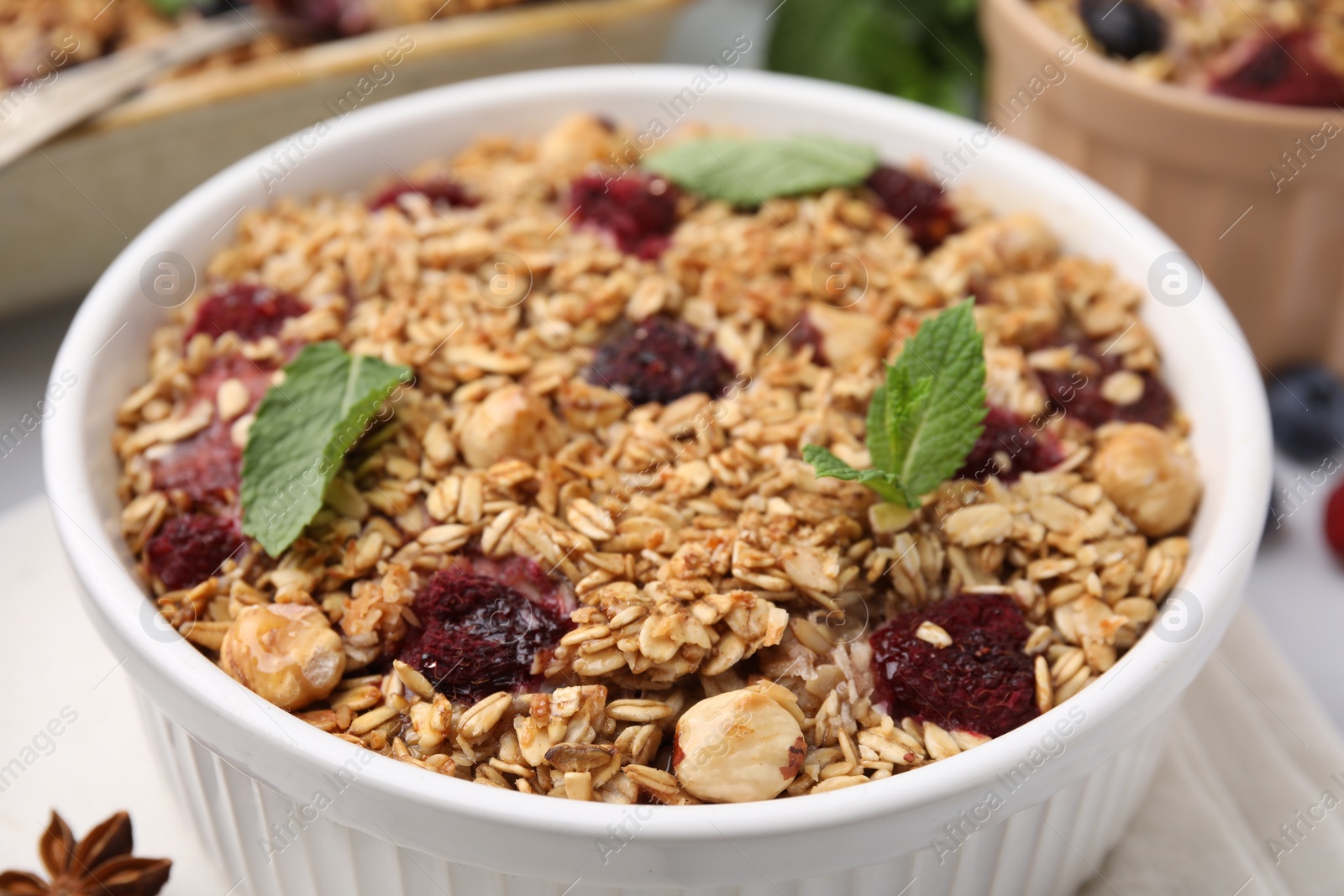 Tasty baked oatmeal with berries and nuts on table, closeup Photo of Tasty baked oatmeal with berries and nuts on table, closeup
