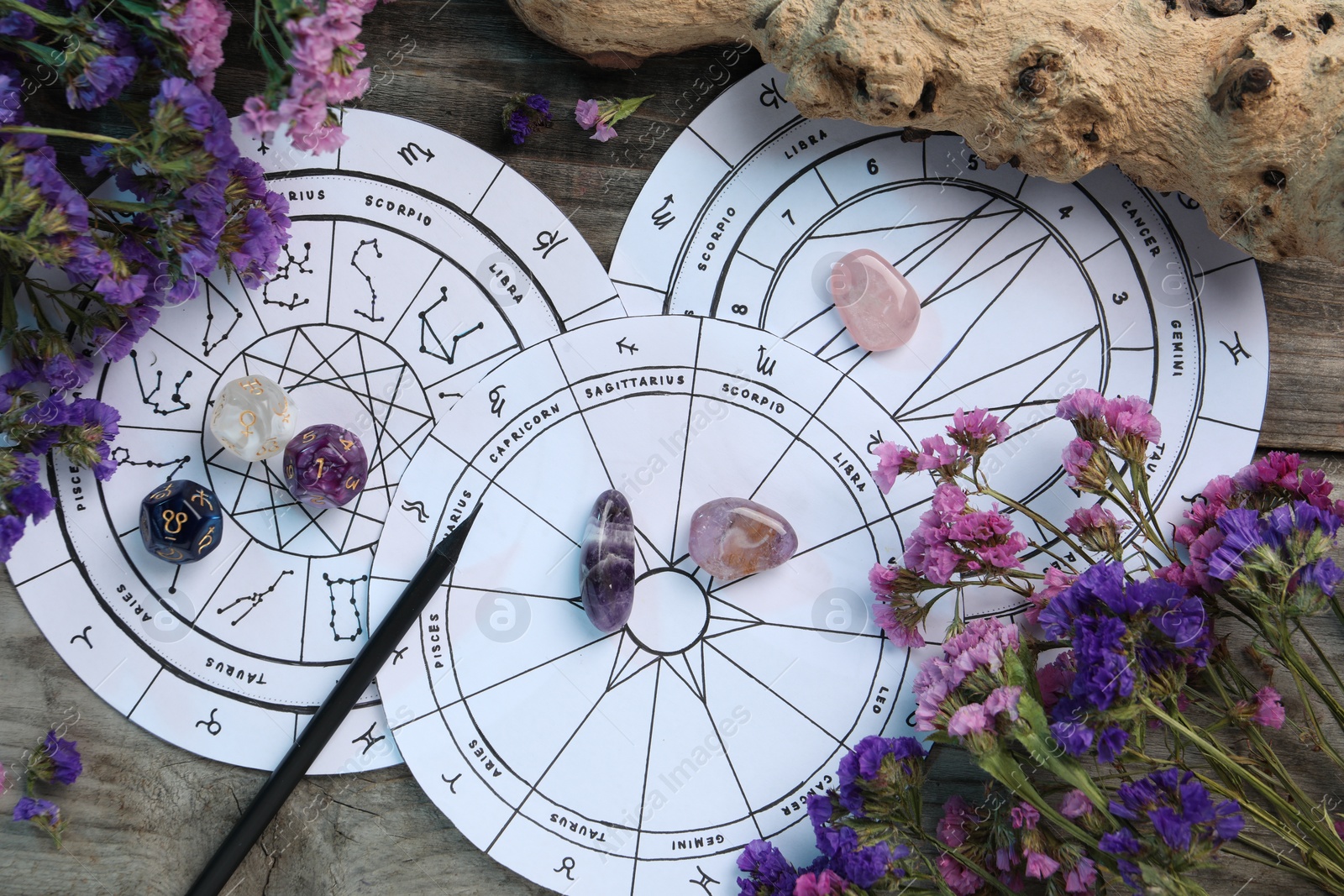 Photo of Flat lay composition with zodiac wheels and astrology dices on wooden table