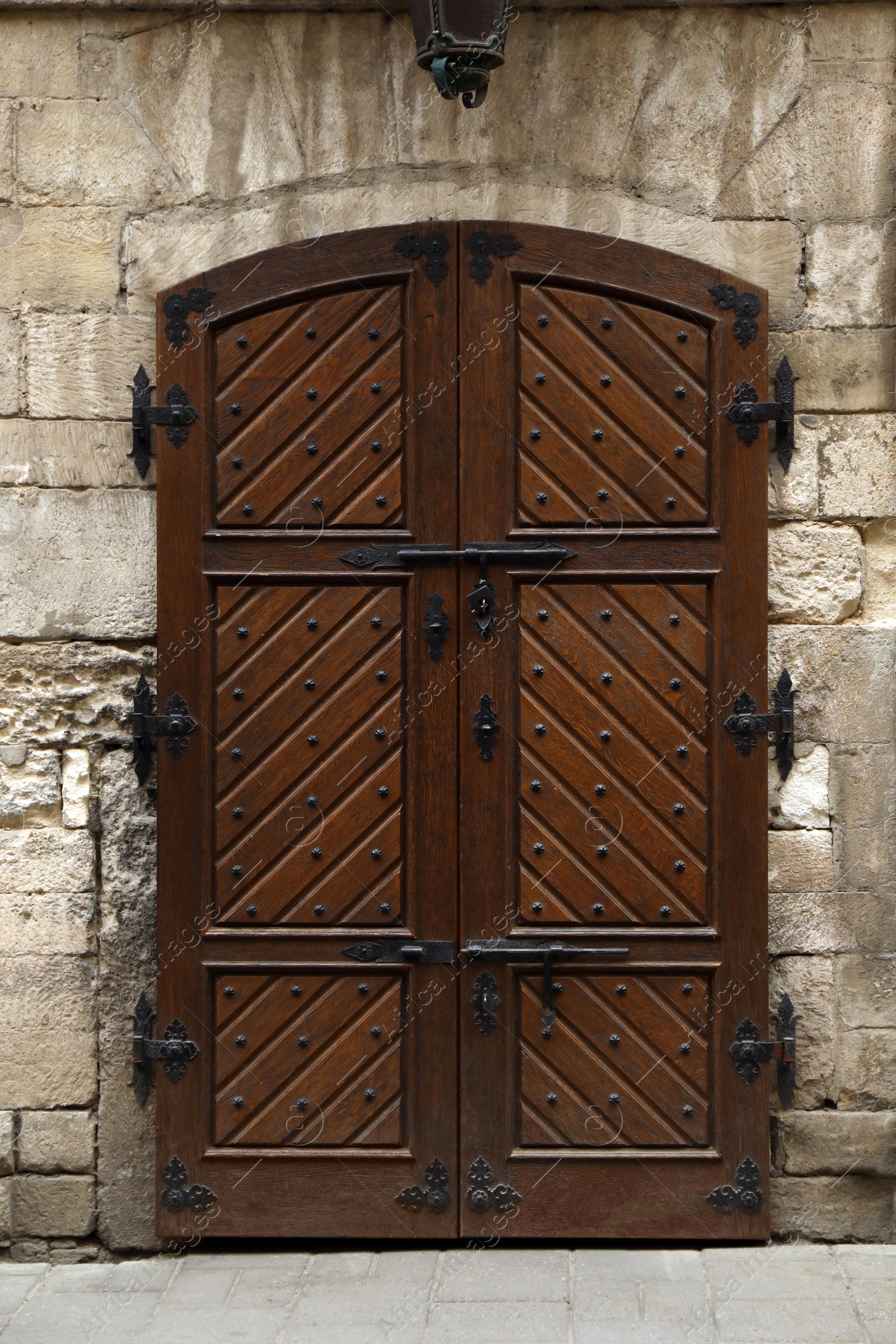 Photo of View of house with beautiful arched wooden door. Exterior design