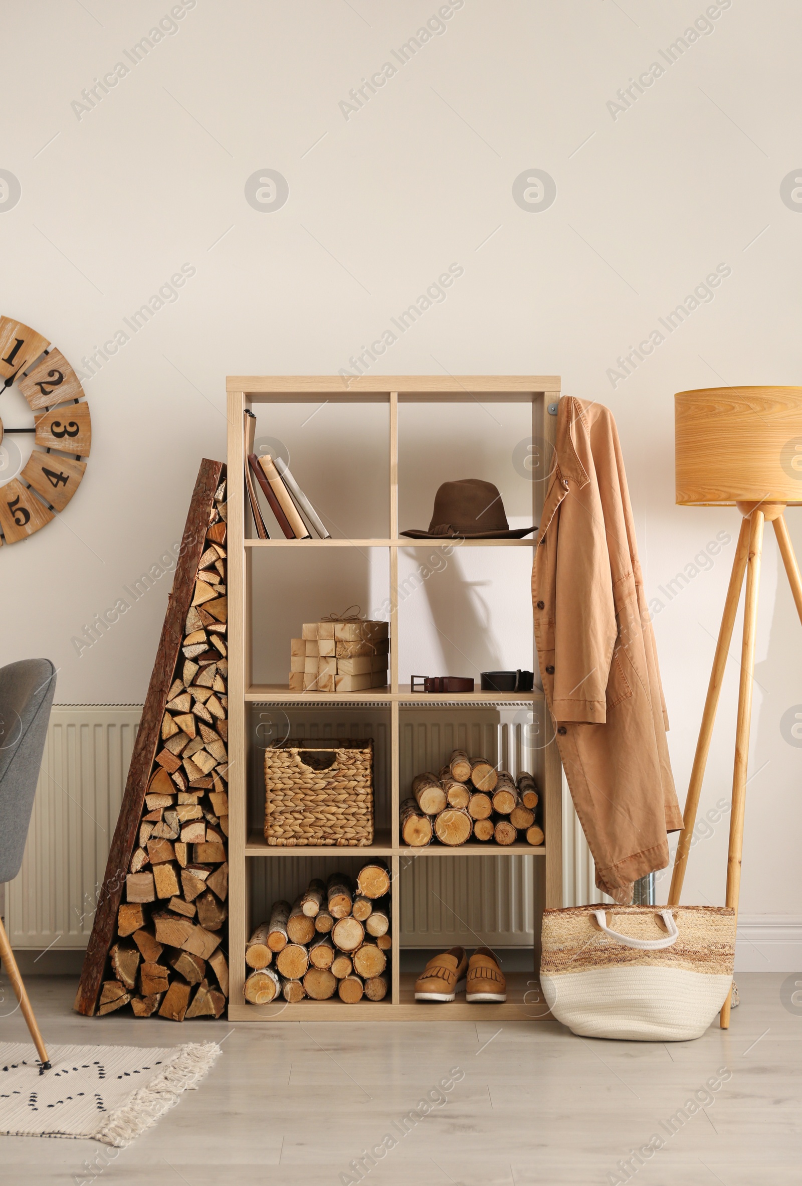 Photo of Stylish room interior with firewood as decorative element