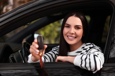 Woman holding car flip key inside her vehicle