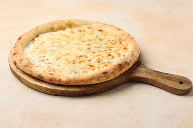 Photo of Delicious cheese pizza on beige textured table