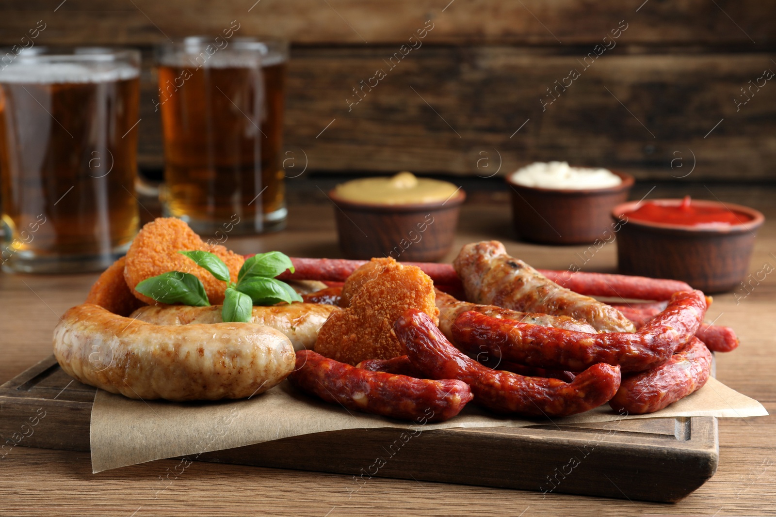 Photo of Set of different tasty snacks on wooden table