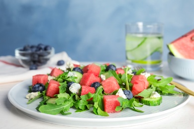 Photo of Delicious salad with watermelon served on white table