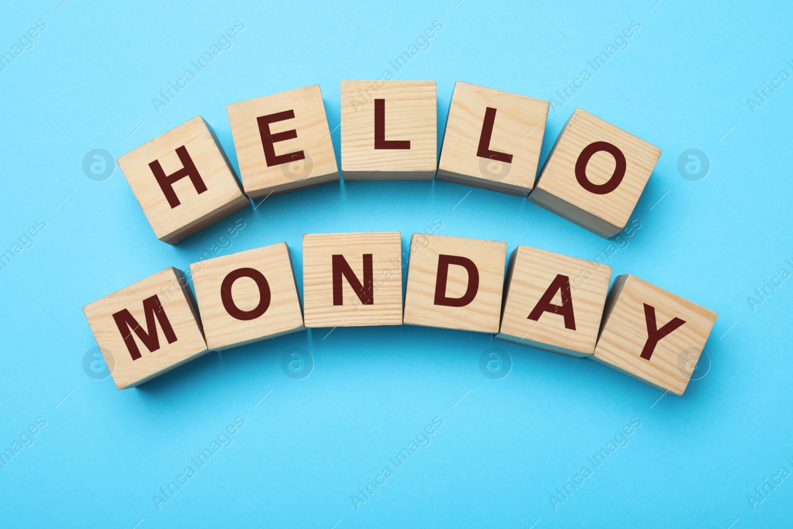 Photo of Wooden cubes with message Hello Monday on turquoise background, flat lay