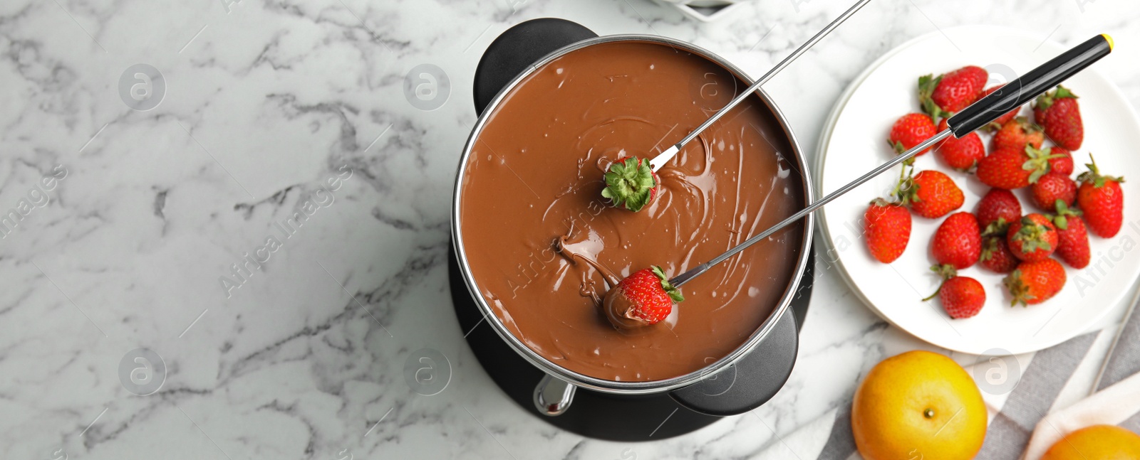 Image of Flat lay composition with chocolate fondue in pot on white marble table, space for text. Banner design