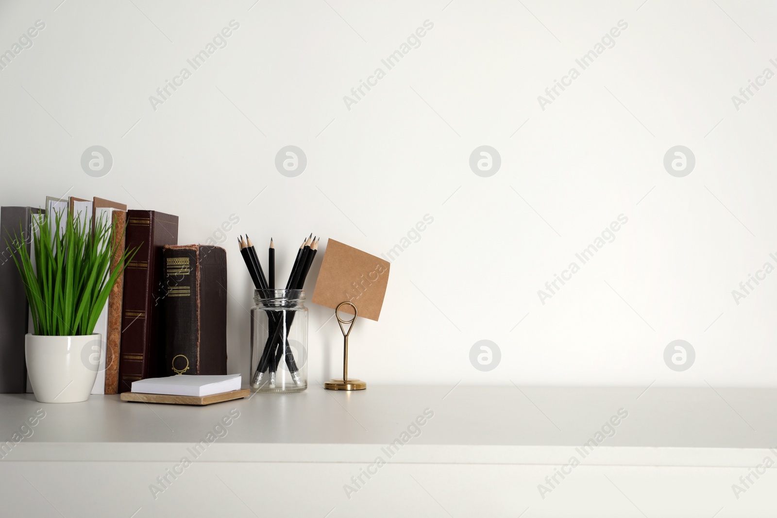 Photo of Comfortable workplace with white desk near wall at home