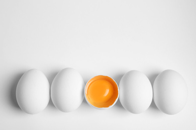 Photo of Fresh raw chicken eggs on white background, flat lay. Space for text