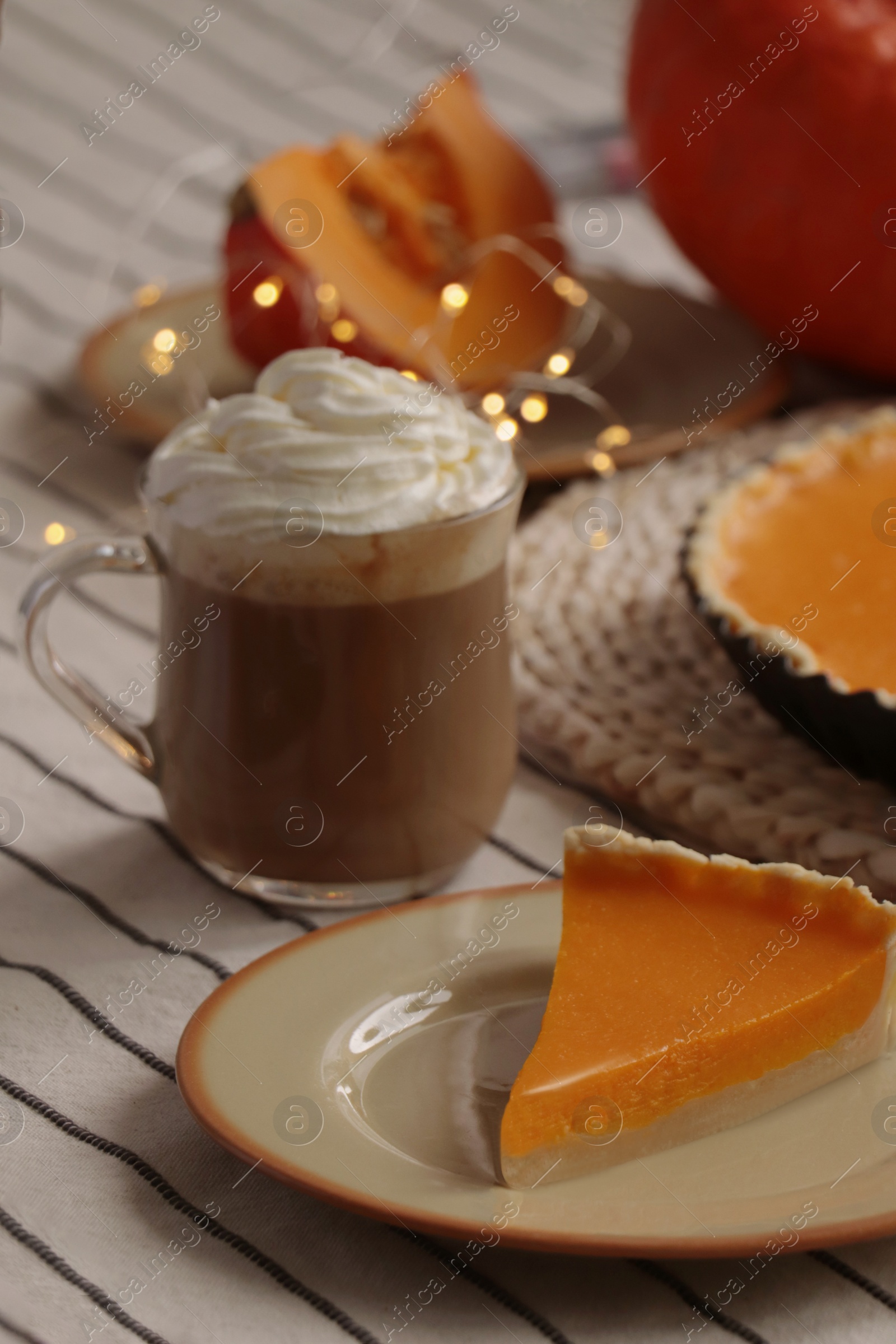 Photo of Fresh homemade pumpkin pie and cup of cocoa with whipped cream on table