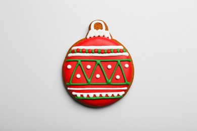 Photo of Tasty cookie in shape of Christmas ball on light background, top view
