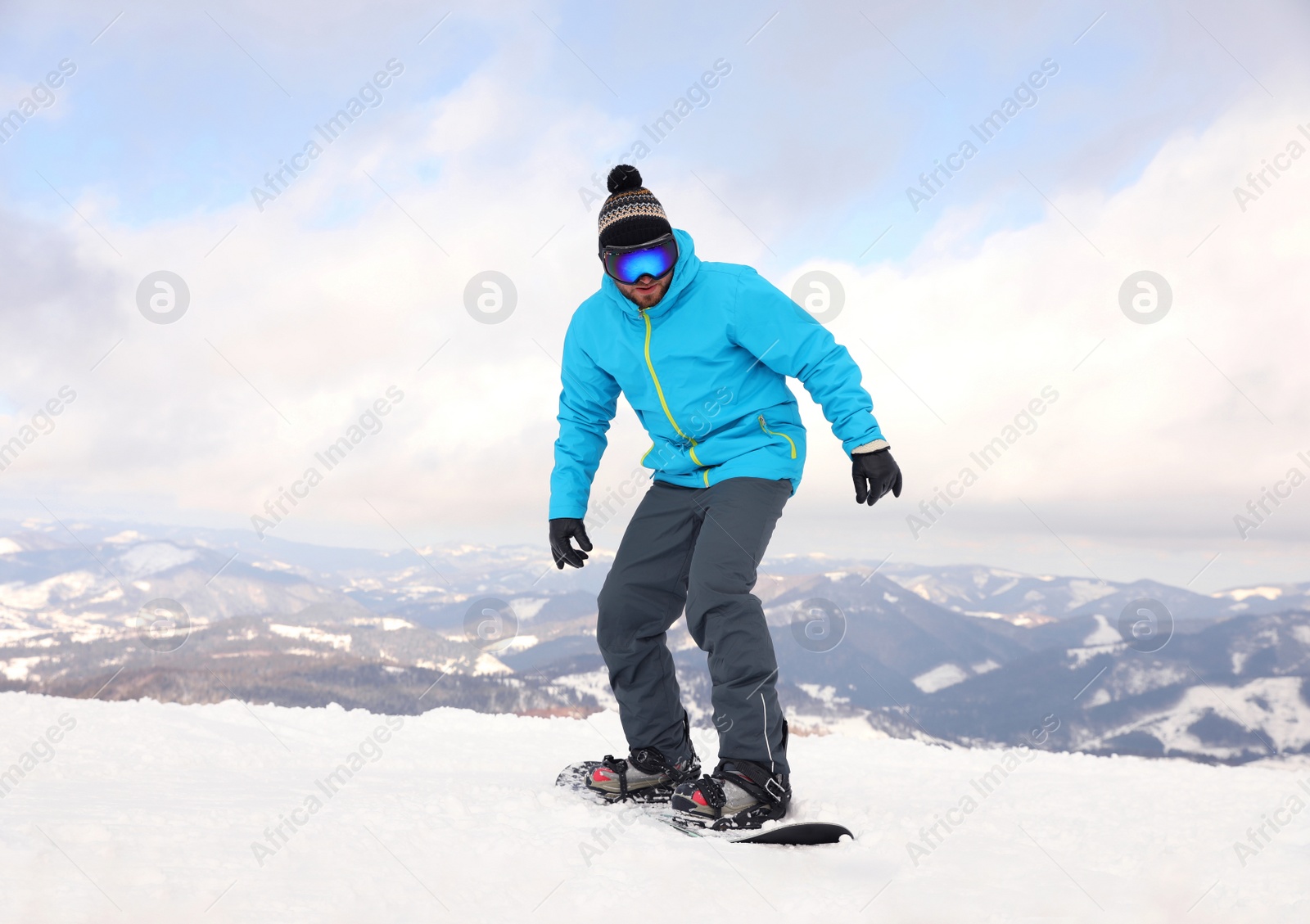 Photo of Male snowboarder on snowy hill. Winter vacation