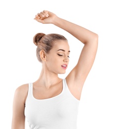 Young woman showing armpit on white background. Using deodorant