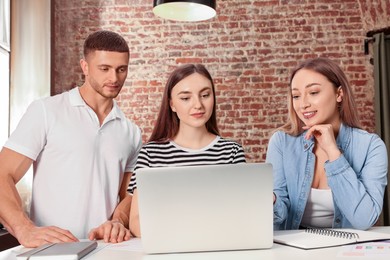 Team of employees working together in office