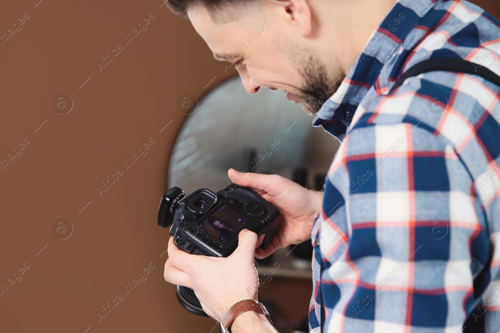 Photo of Professional photographer with camera in studio