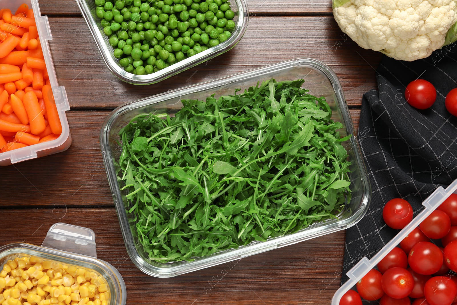 Photo of Containers with fresh products on wooden table, flat lay. Food storage