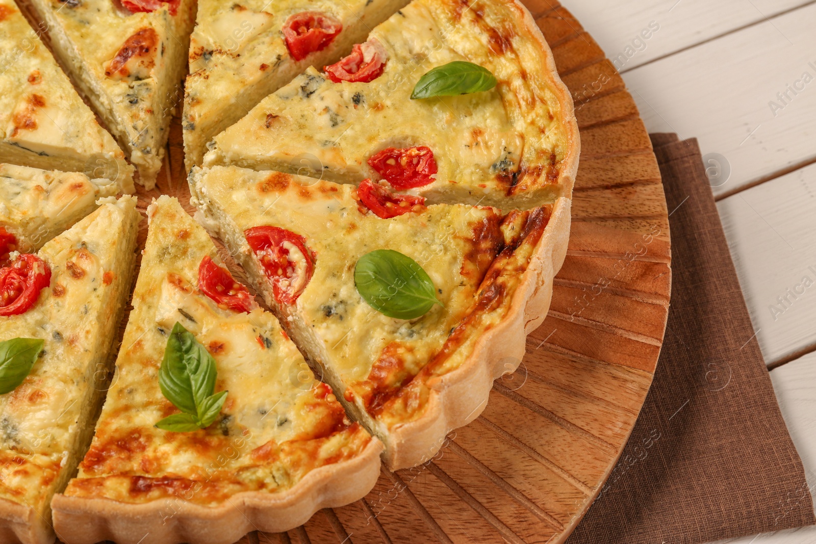 Photo of Delicious homemade cheese quiche on white table, closeup