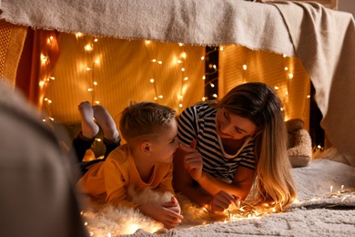Mother and her son in play tent at home