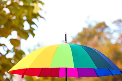 Photo of Bright color umbrella outdoors. Protection from rain