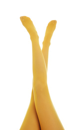 Photo of Woman wearing yellow tights on white background, closeup of legs
