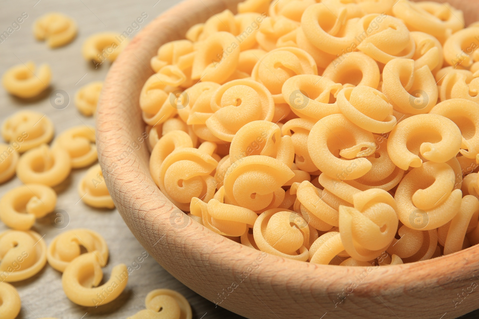 Photo of Raw dischi volanti pasta in bowl on table, closeup