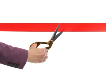 Woman in office suit cutting red ribbon isolated on white, closeup