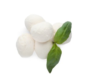 Delicious mozzarella cheese balls and basil on white background, top view