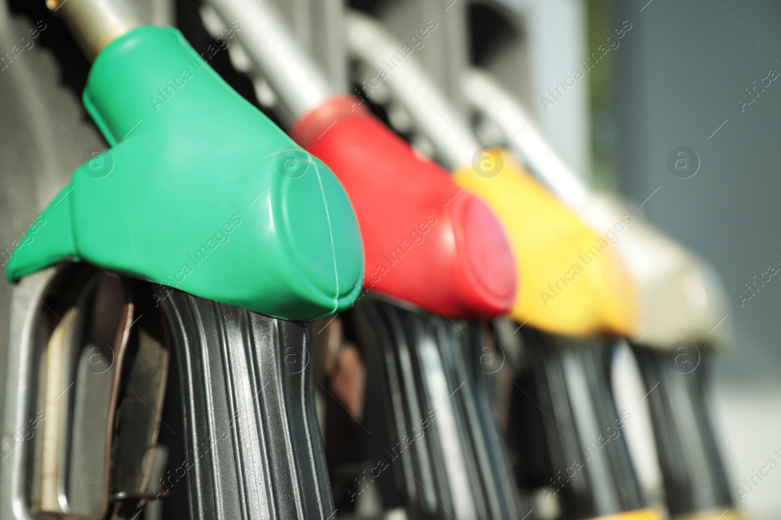 Photo of Fuel pistols at modern gas filling station, closeup