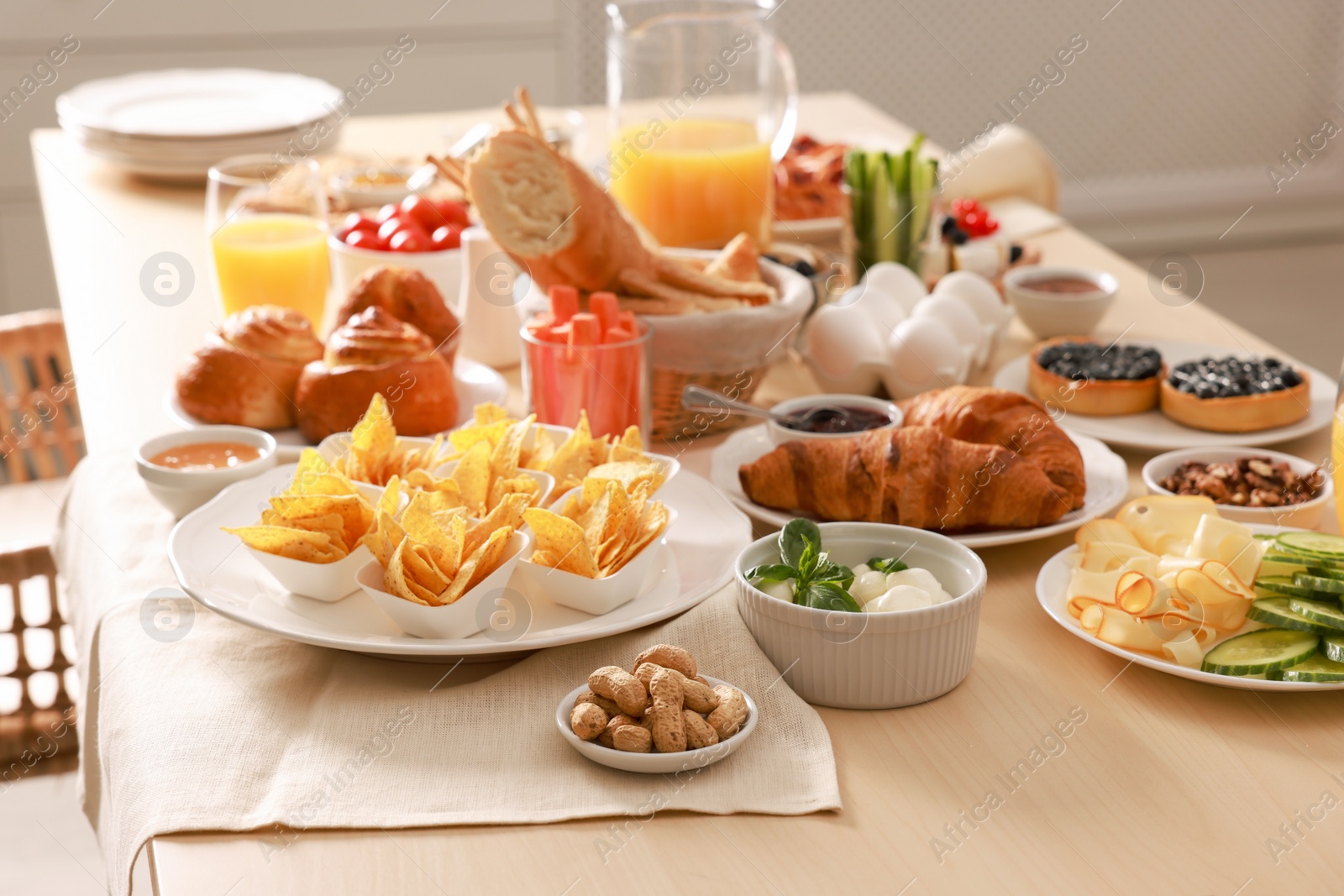 Photo of Dishes with different food on table in room. Luxury brunch