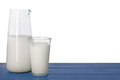 Photo of Glassware with tasty milk on blue wooden table against white background