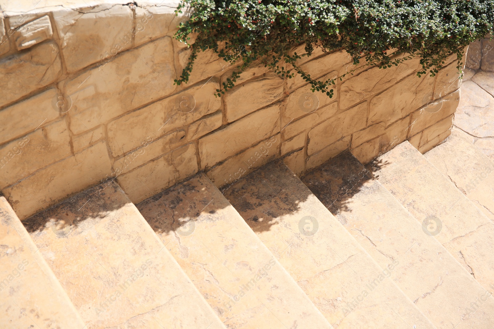 Photo of View of beautiful stone stairs near brick wall outdoors